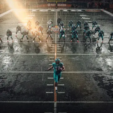 Arizona Cardinals running back James Conner carrying the ball in a red Cardinals uniform during an N
