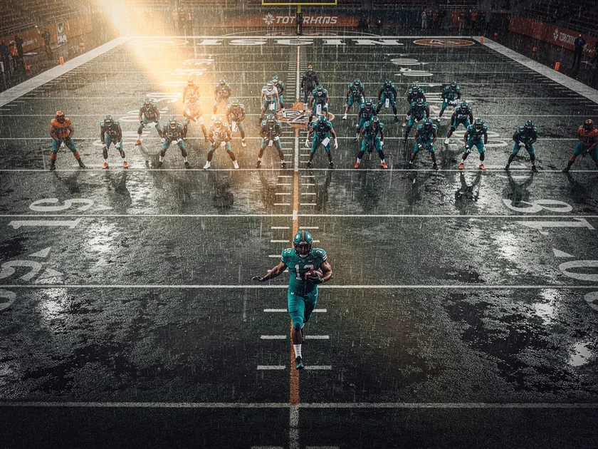Arizona Cardinals running back James Conner carrying the ball in a red Cardinals uniform during an N