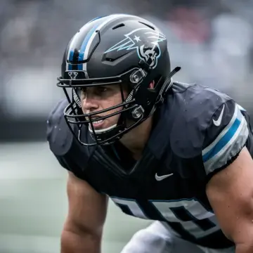 Dallas Cowboys helmet on draft board representing the team's 2026 NFL Draft defense strategy